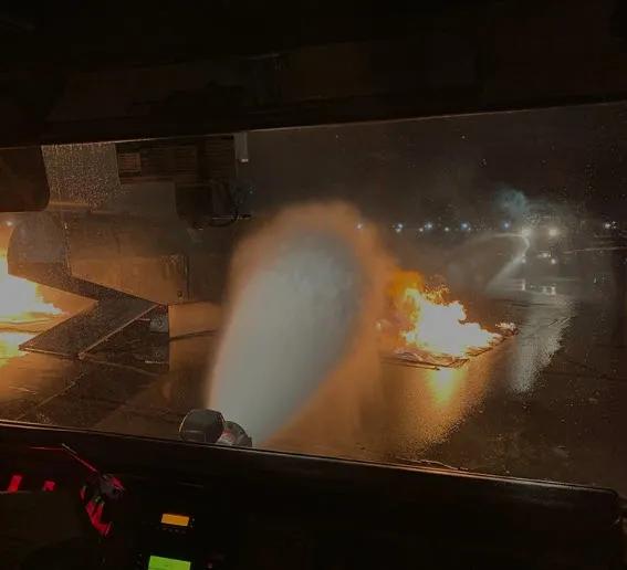 Firefighting foam spraying on airport runway fire.